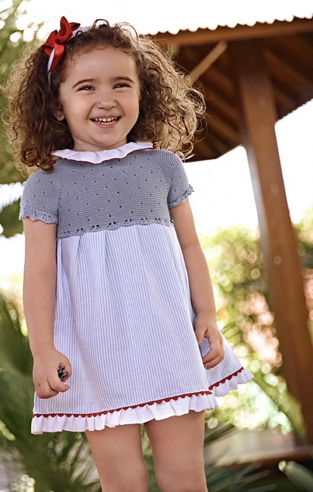 Powder blue knitted dress with striped fabric.