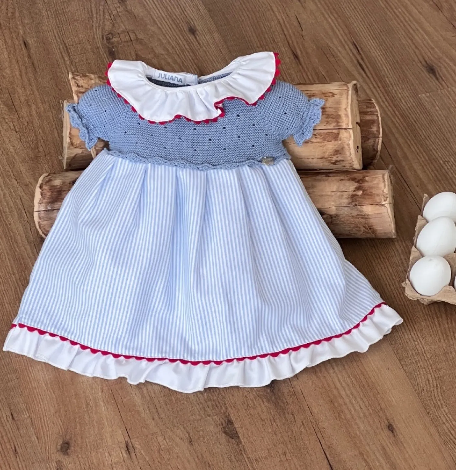 Powder blue knitted dress with striped fabric.